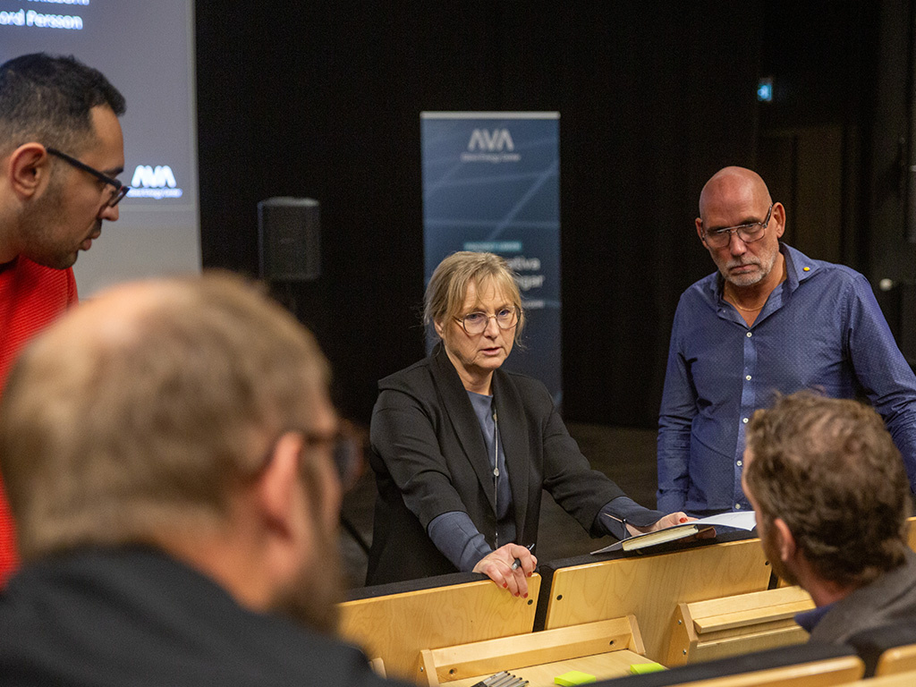 Fem personer, en kvinna och fyra män, samtalar om energifrågor.